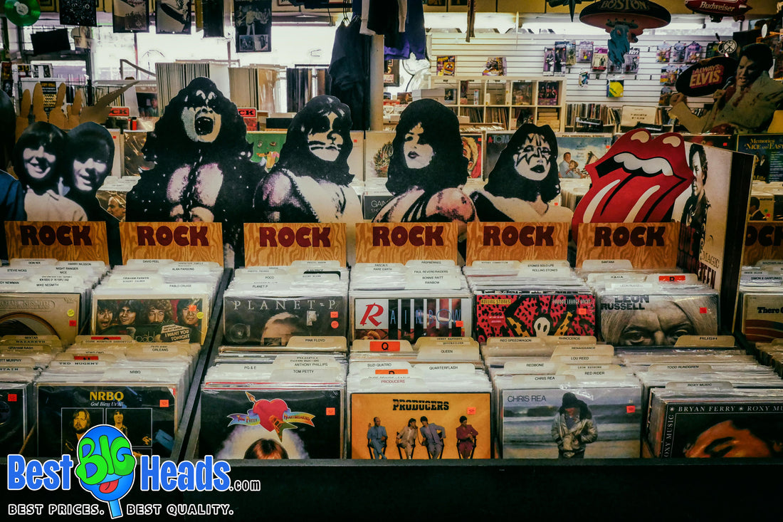 Vintage 1970s rock 'n' roll cardboard cutouts of iconic band members displayed above vinyl records in a nostalgic record store.