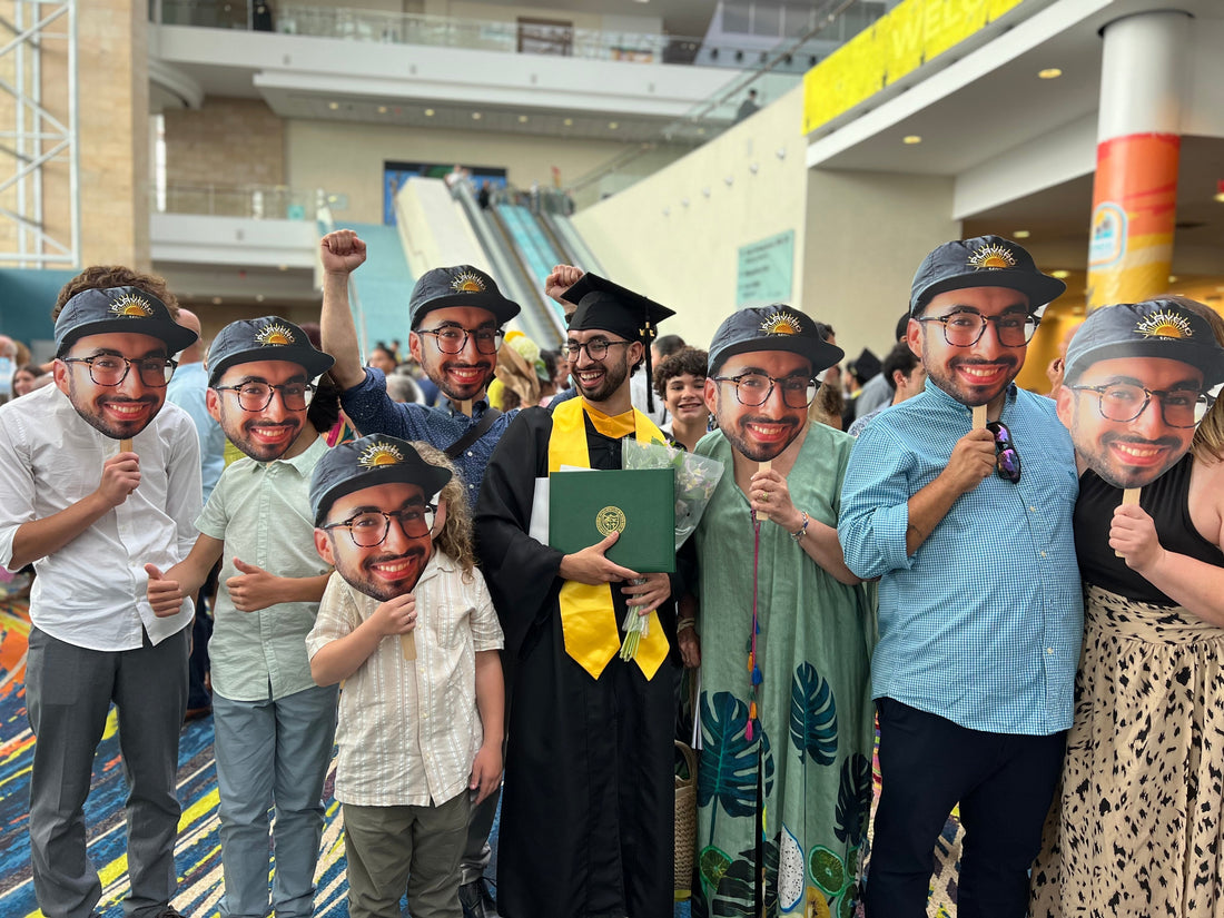 Group of family and friends proudly holding Big head Cutouts of their newly grad loved one t celebre his milestone achievement
