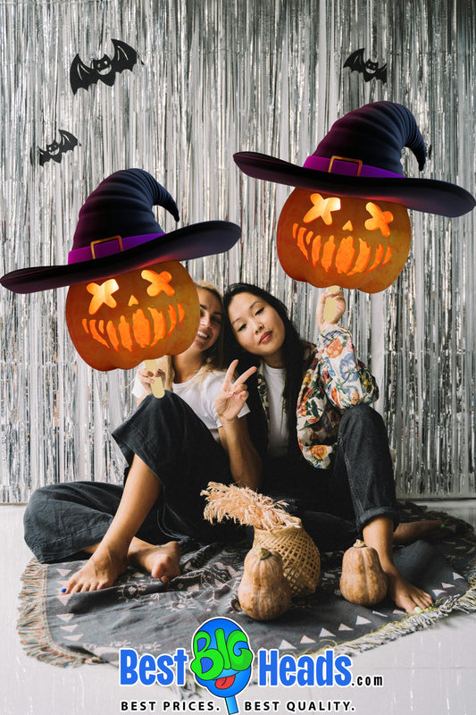 Two friends smiling as they hold a large pumpkin-shaped cutout from Best BIG Heads™, ready to surprise everyone with their fun and festive Halloween décor.