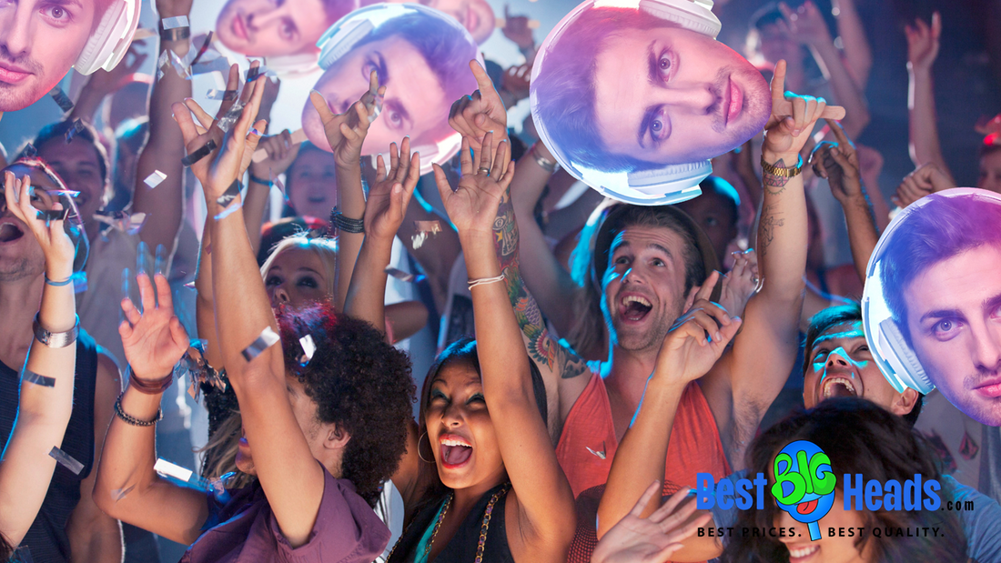 A group of enthusiastic people at a lively event are holding up oversized head cutouts of a man wearing headphones. 