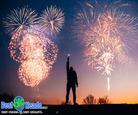 Person holding a sparkler under a sky full of fireworks during a 4th of July celebration, symbolizing the excitement of Independence Day with Best BIG Heads™