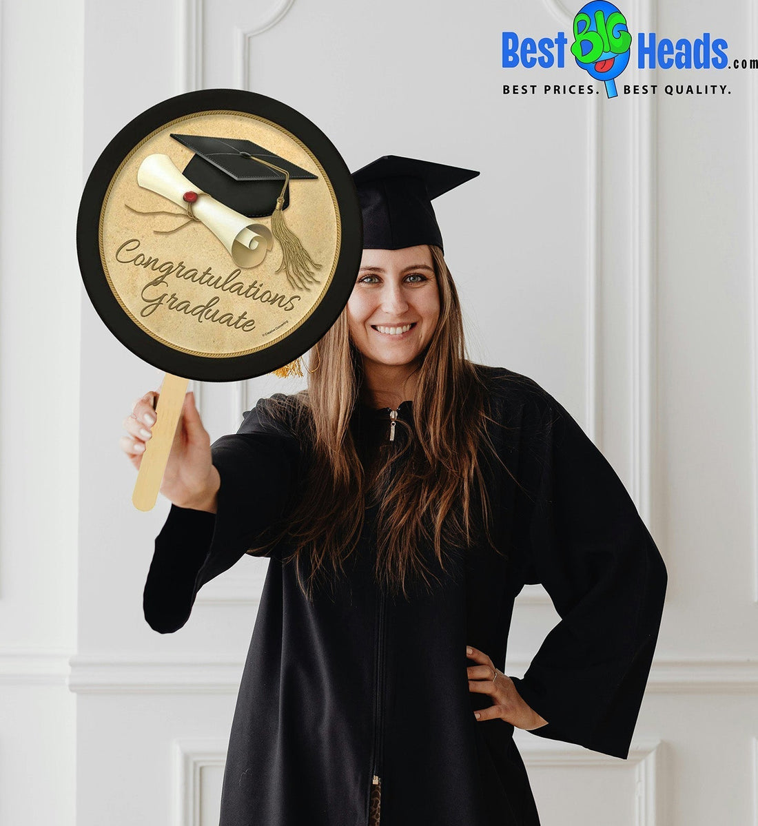 A newly graduated student smiling and holding a large custom Best BIG Head cutout.